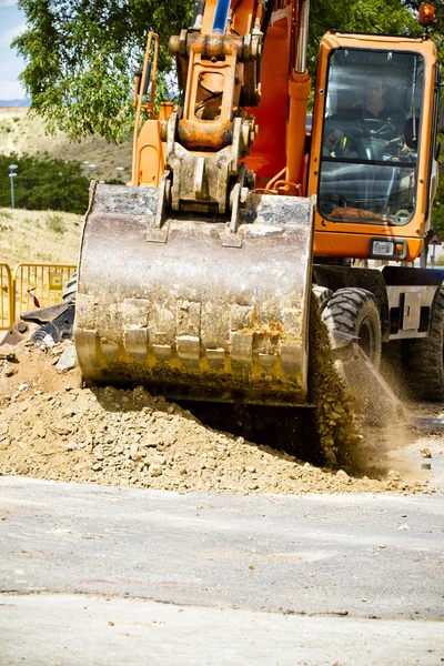 Orange excavator at work in a large sandpit — Stock Photo, Image