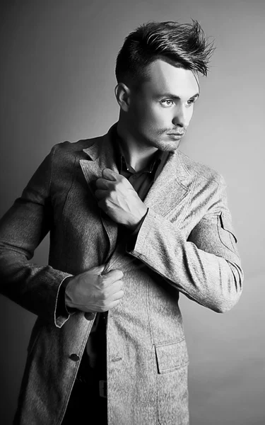Portrait of male fashion model with stylish hairstyle and makeup ...