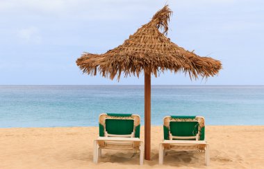 Palapa sun roof beach umbrella in cape verde clipart