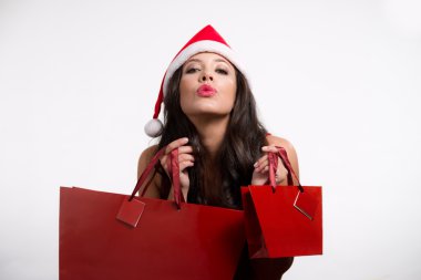 Beautiful brunette girl holding christmas shopping bags clipart