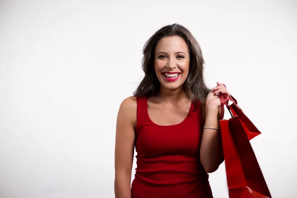 Beautiful brunette girl holding shopping bags — Stock Photo, Image