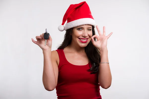 Christmas girl holding a car key — Stock Photo, Image