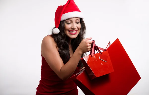 Hermosa chica morena sosteniendo bolsas de compras de Navidad Fotos de stock libres de derechos