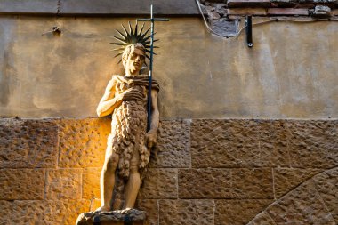 Statue on the House Facade in Volterra, Tuscany, Italy clipart