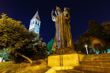 Gregory of Nin Statue and Bell Tower in Split at Night, Croatia clipart
