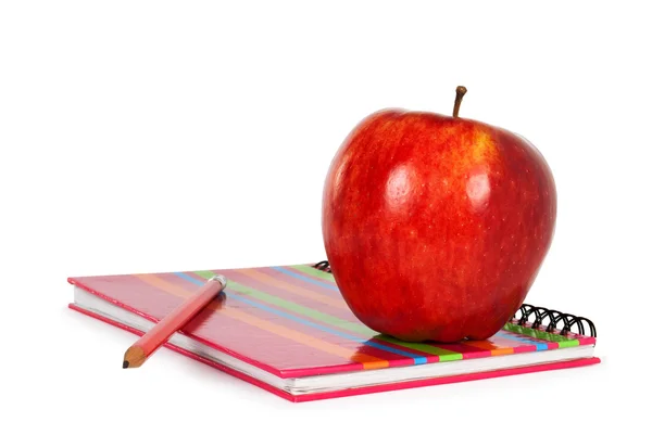Notizbuch und Apfel Stockbild