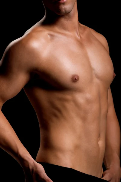 Zdrowe mięśni młody człowiek. na białym tle na czarnym tle. — Zdjęcie stockowe