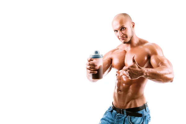 Athletic young handsome man with shake bottle. Royalty Free Stock Photos