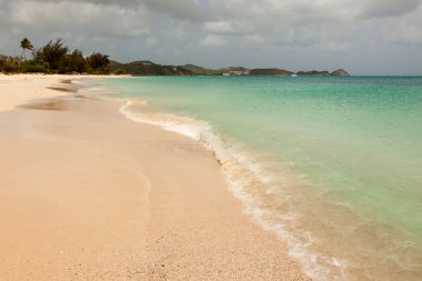 Tropical Sandy Caribbean Beach with Cloudy Overcast Sky clipart