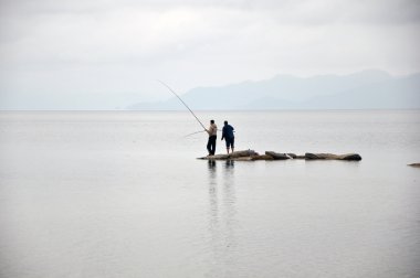 Fishermen on the island. clipart