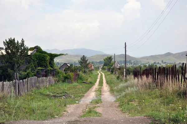 stock image The road along the fence.