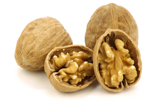Two fresh walnuts and a cracked one — Stock Photo, Image