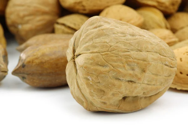 Tasty walnut in front of mixed nuts — Stock Photo, Image