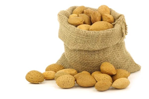 Bunch of almond nuts in a burlap bag — Stock Photo, Image