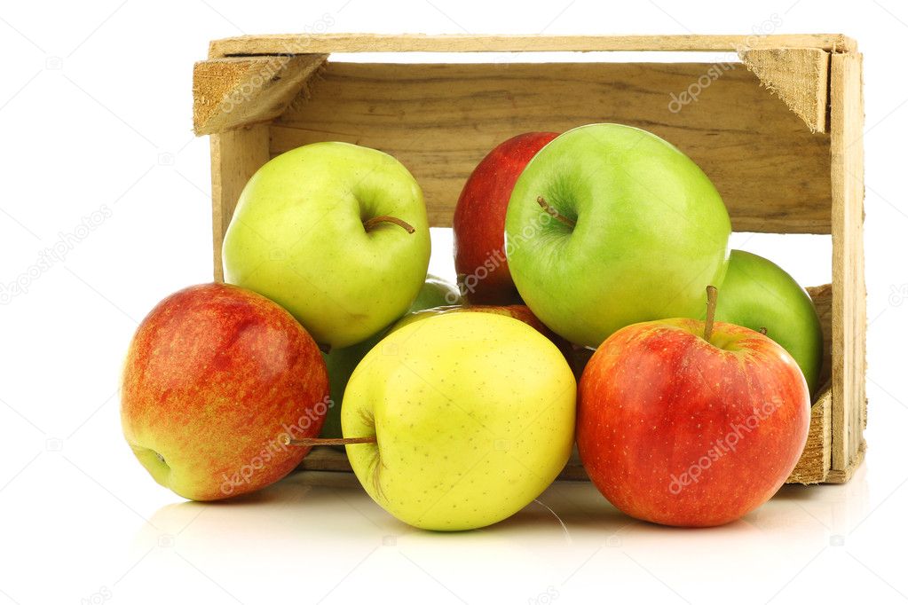 Assorted fresh apples in a wooden crate