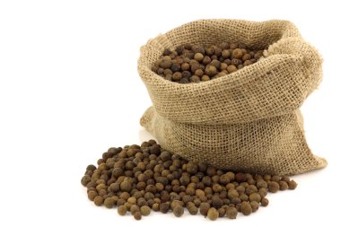 Dried allspice(Jamaica pepper) in a burlap bag clipart