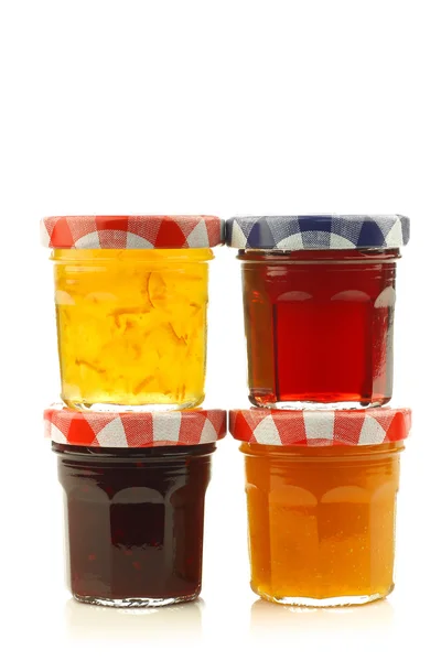 Stacked glass jars with assorted jam and marmalade — Stock Photo, Image