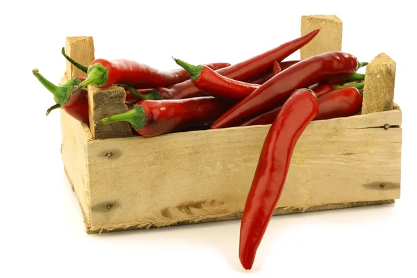 Fresh red chili peppers in a wooden crate — Stock Photo, Image