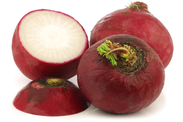 Fresh big red radishes and a cut one — Stock Photo, Image