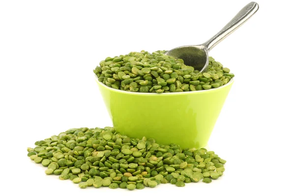 Split green peas in a green bowl with an aluminum scoop — Stock Photo, Image
