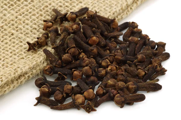 Dried cloves on a burlap cloth — Stock Photo, Image