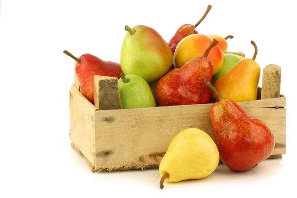 Assortment of different colorful pears in a wooden crate — Stock Photo, Image