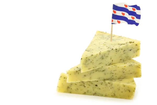 Stacked pieces of traditional frisian cheese with herbs and a frisian flag toothpick — Stock Photo, Image