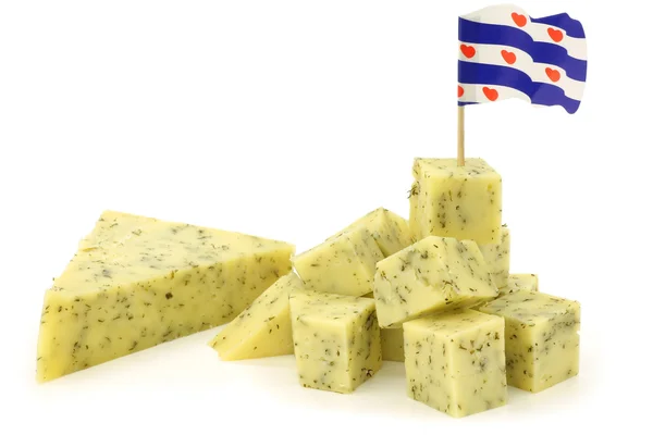 Stock image Stacked pieces of traditional frisian cheese with herbs and a frisian flag toothpick