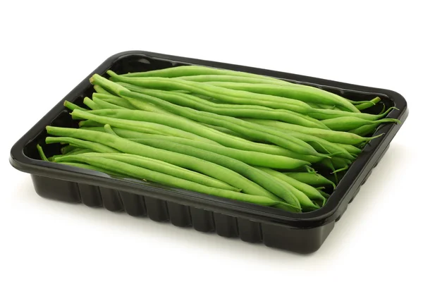 Small and slender green beans (haricot vert) in a black plastic container — Stock Photo, Image