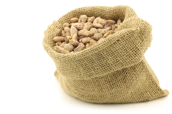 Speckled beans in a burlap bag — Stock Photo, Image