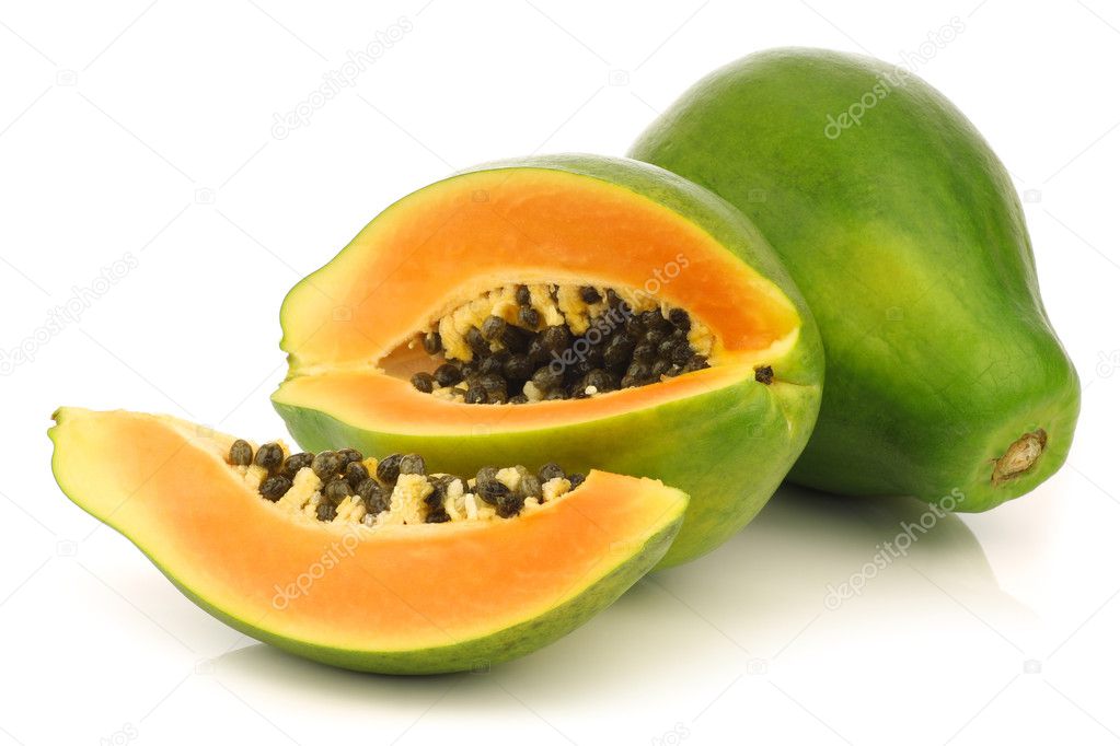 Fresh papaya fruit and a cut one