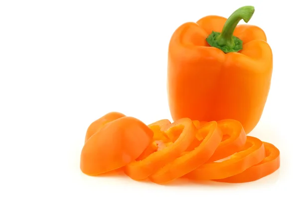 Fresh orange bell pepper and a cut one — Stock Photo, Image