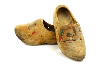 Pair of very old traditional Dutch decorated wooden shoes clipart