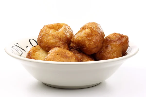 Powdered Dutch oliebollen in a white bowl — Stock Photo, Image