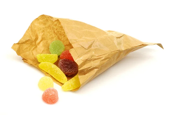 Papírový sáček s barevné sladkosti — Stock fotografie