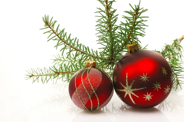 Red christmas balls with a green fir branch — Stock Photo, Image