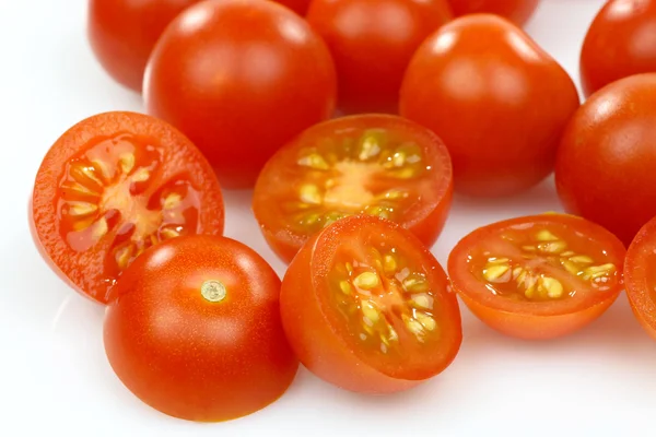 Whole and sliced cherry tomatoes — Stock Photo, Image