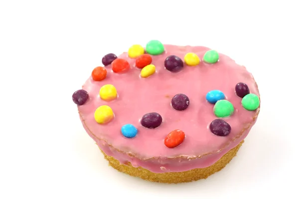 Cake with pink icing and colorful sprinkles — Stock Photo, Image