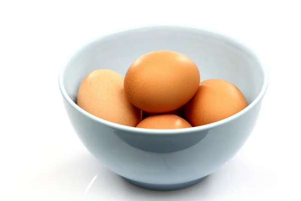 Blue bowl with eggs — Stock Photo, Image
