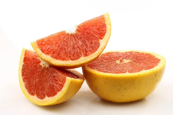 stock image Fresh and juicy red grapefruit halves and slices