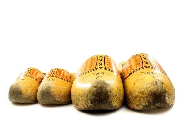 Old and young two pairs of traditional Dutch yellow wooden shoes — Stock Photo, Image