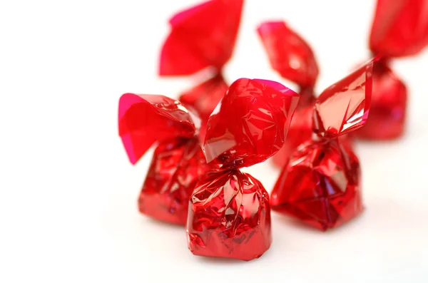 Bonbons in rotes glänzendes Papier gewickelt fertig zum Essen (flache dof) — Stockfoto