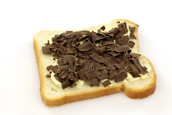 Slice of buttered white bread with chocolate flakes — Stock Photo, Image
