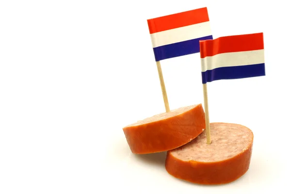 Dos piezas de salchicha ahumada con palillos de dientes de bandera holandesa —  Fotos de Stock