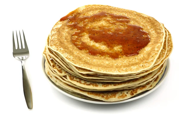 A plate with stacked freshly baked pancakes with a fork — Stock Photo, Image