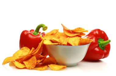 Two red bell peppers and paprika chips in a bowl clipart