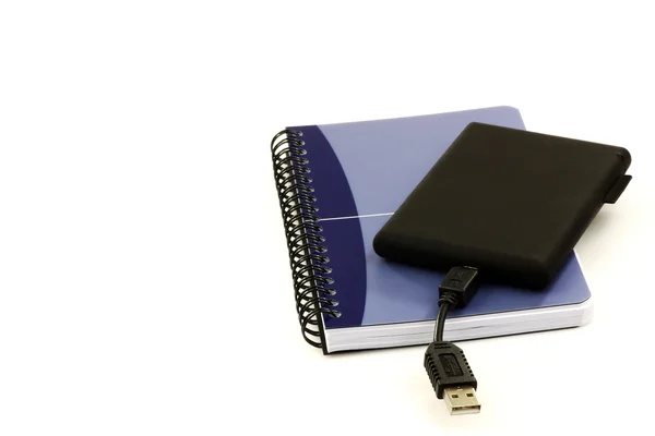 Old fashioned notebook and an external hard drive, old and new — Stock Photo, Image