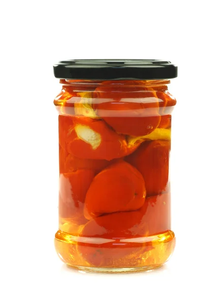 Glass jar with red little sweet peppers filled with cheese — Stock Photo, Image