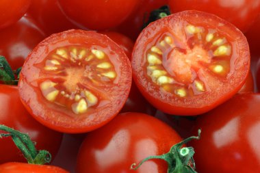 Cherry tomatoes and a cut one clipart