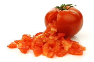 Fresh tomato with front side opened and already cut pieces coming out clipart